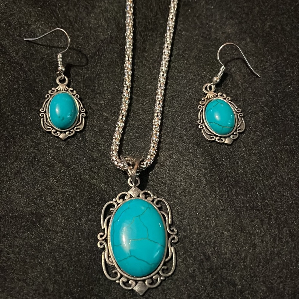 Turquoise and silver colored necklace and earrings.